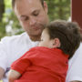 boy sleeping on dad